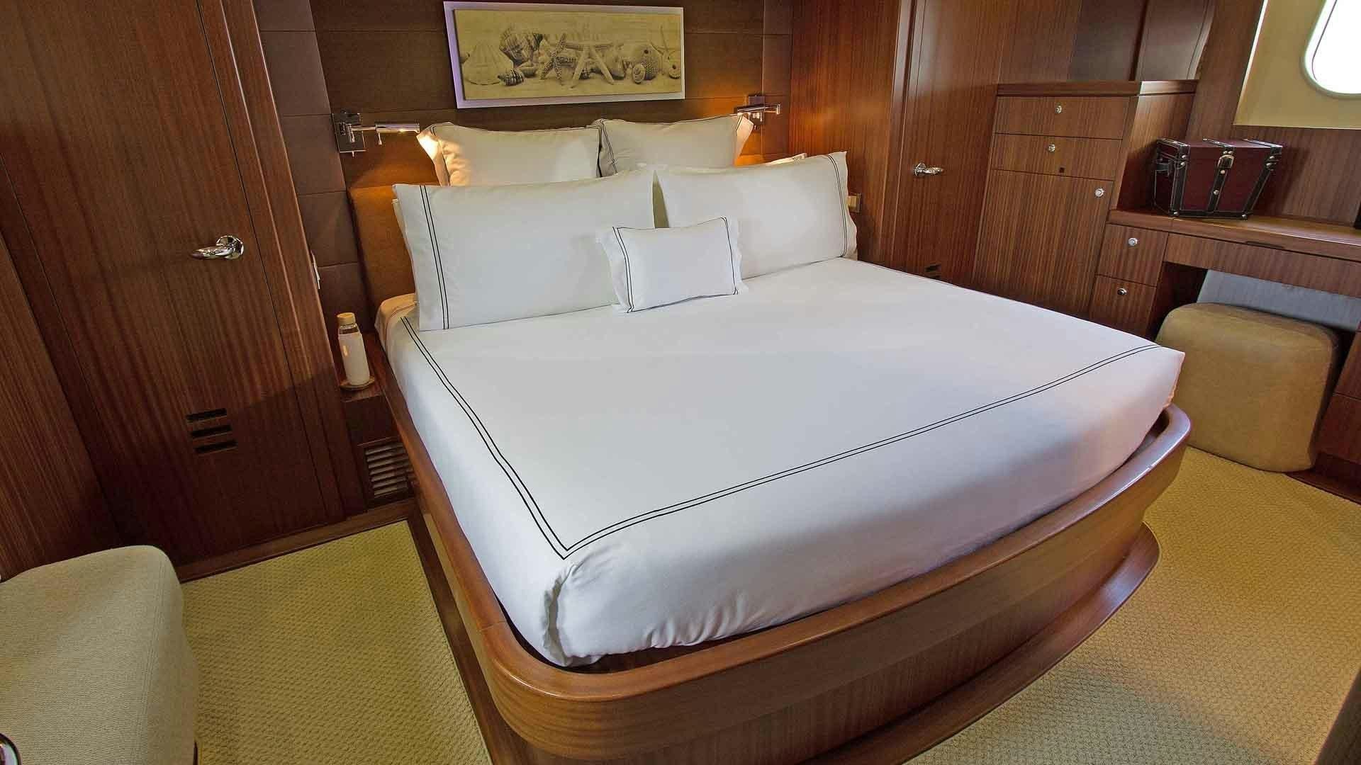 a bed with white sheets aboard JUS CHILL'N Yacht for Sale