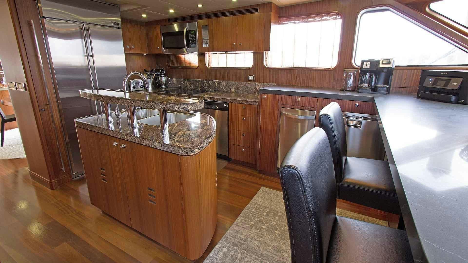 a kitchen with a sink and cabinets aboard JUS CHILL'N Yacht for Sale
