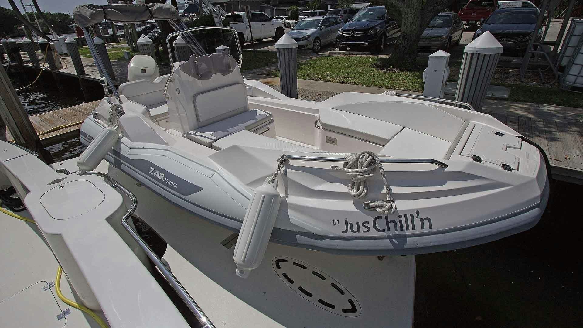 a white boat with a hood aboard JUS CHILL'N Yacht for Sale