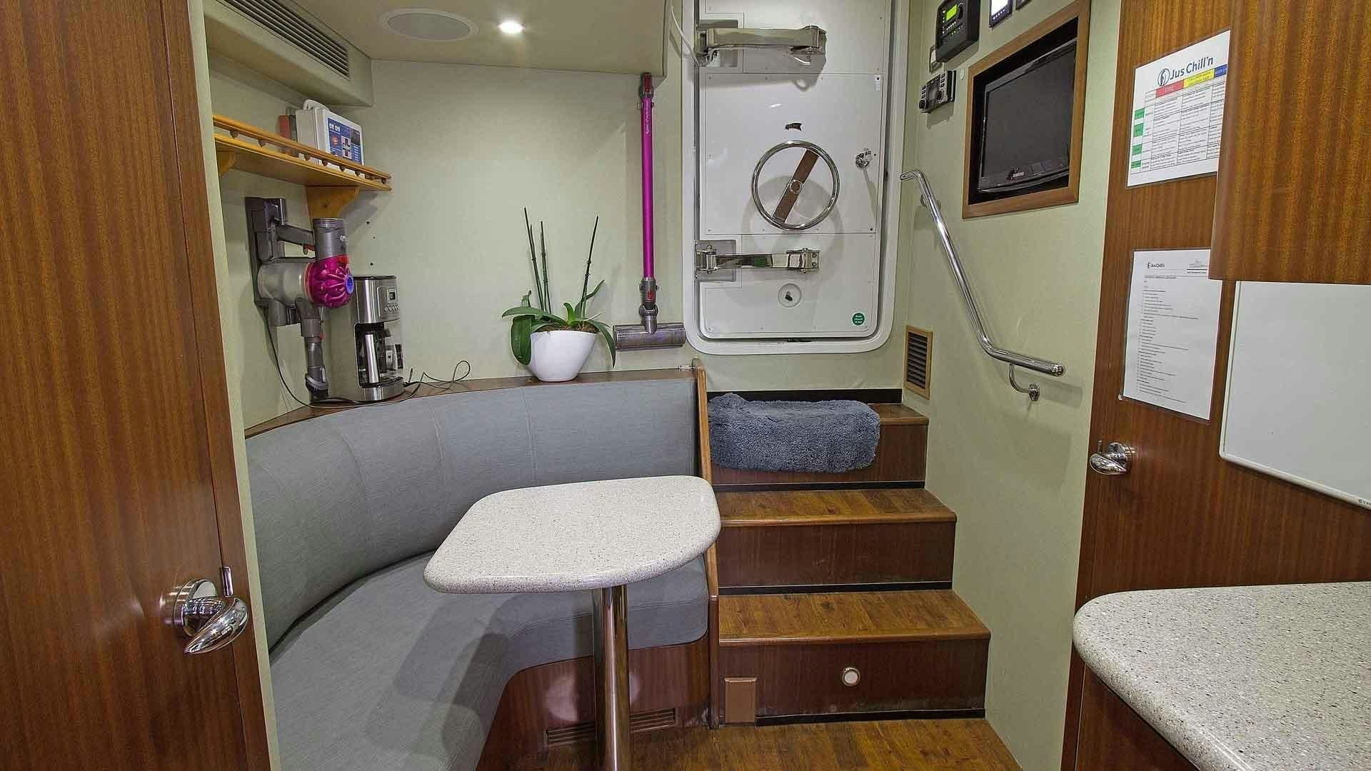a room with a table and chairs aboard JUS CHILL'N Yacht for Sale