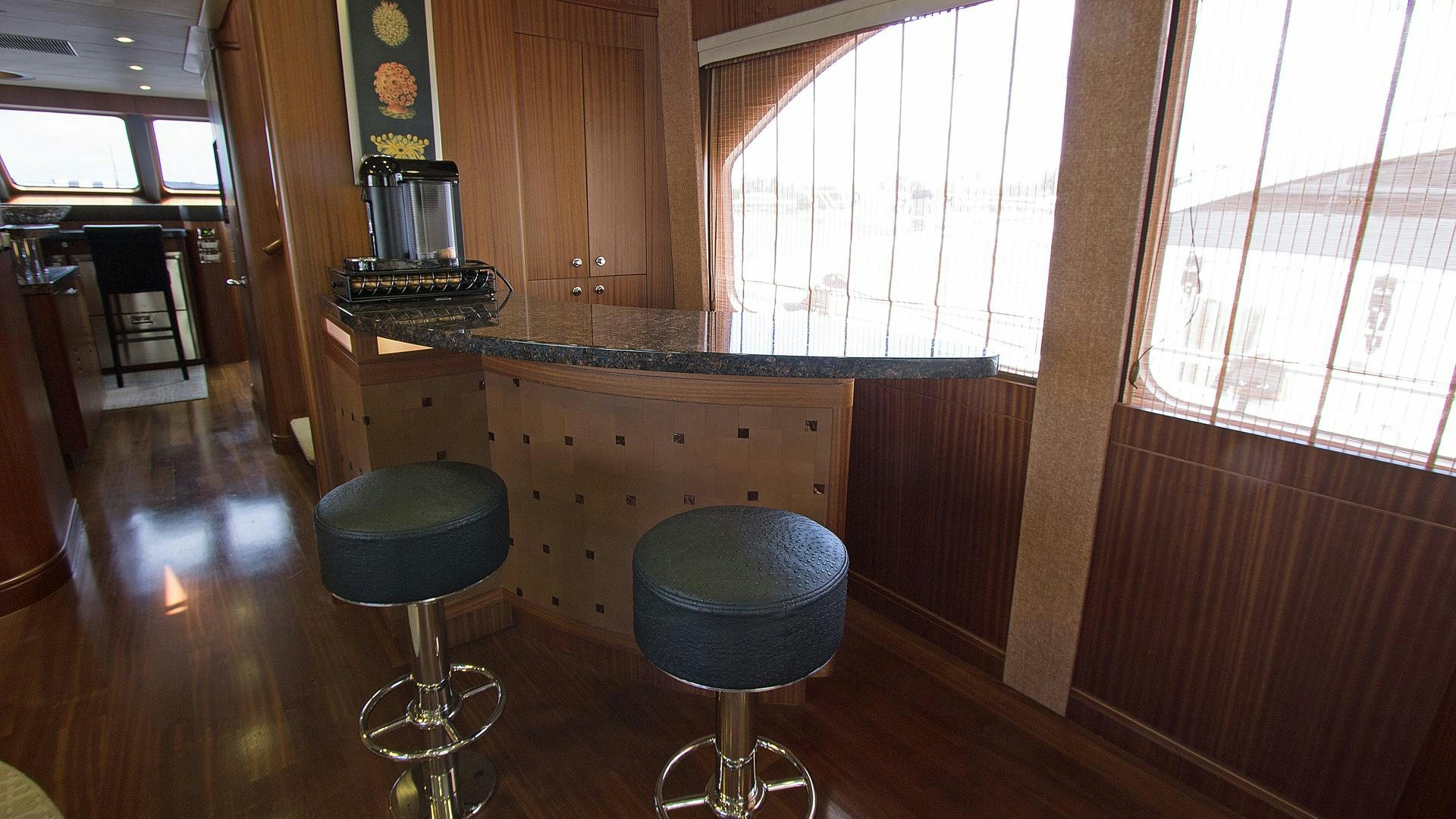 a kitchen with stools and stools aboard JUS CHILL'N Yacht for Sale