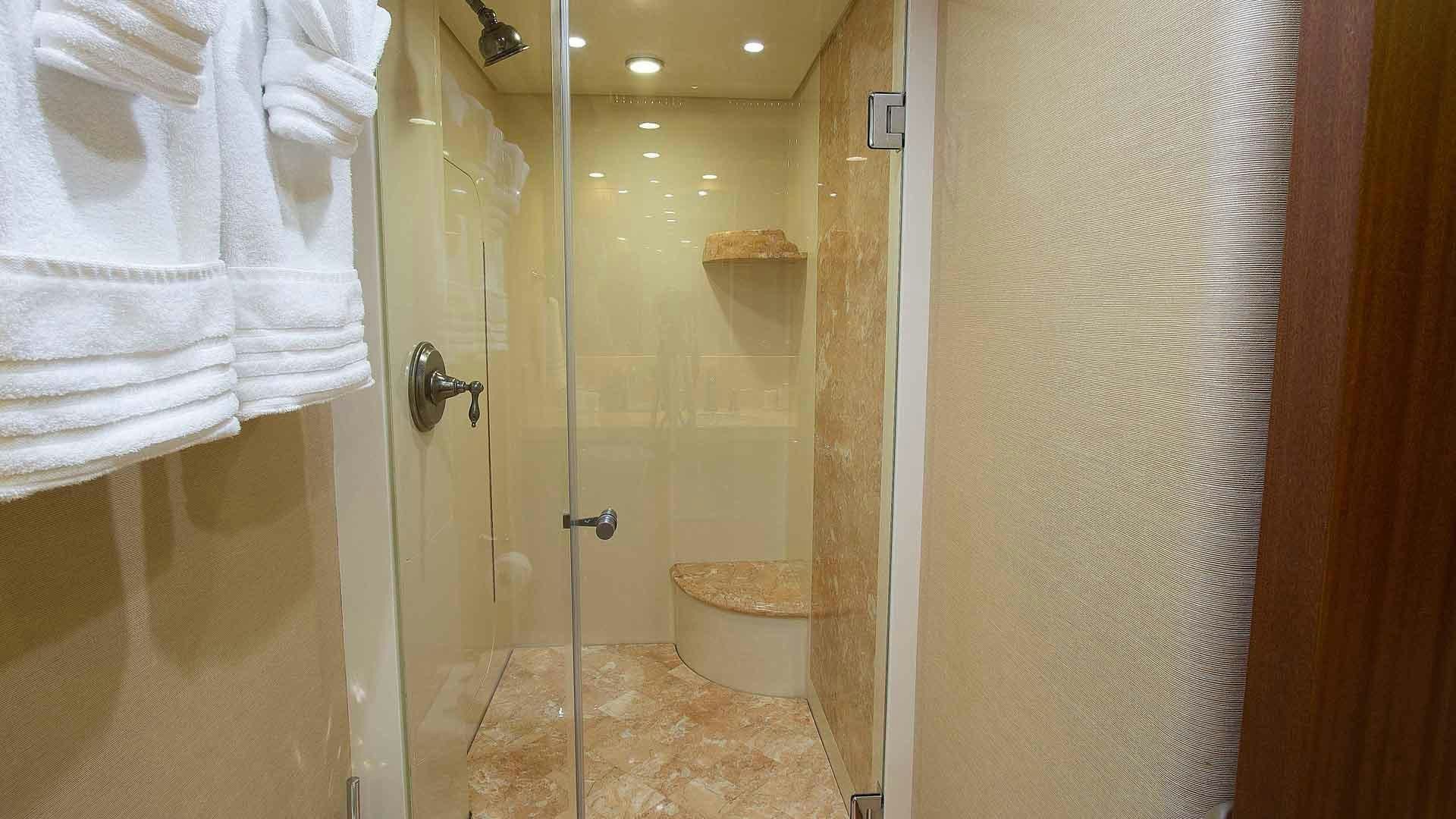 a bathroom with a glass shower aboard JUS CHILL'N Yacht for Sale
