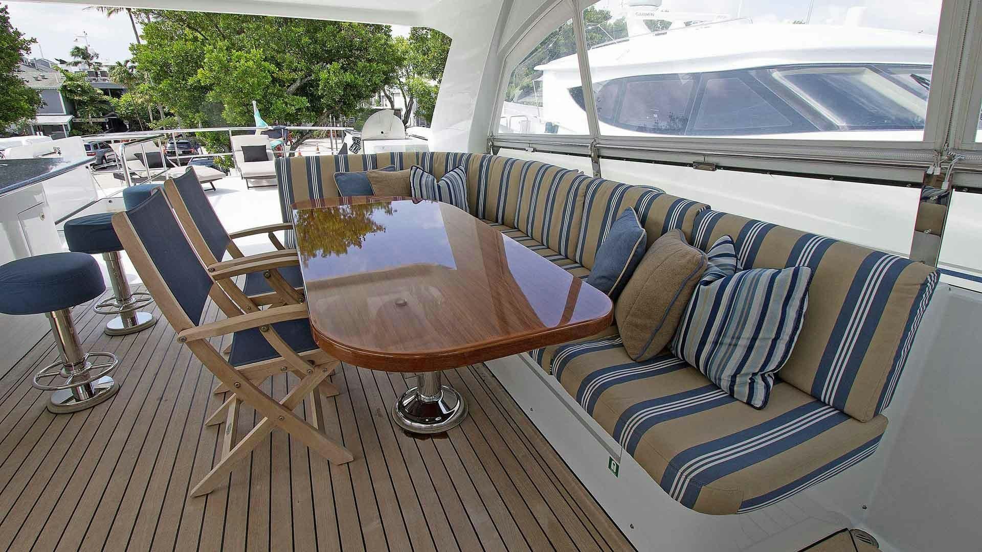 a table and chairs on a deck aboard JUS CHILL'N Yacht for Sale