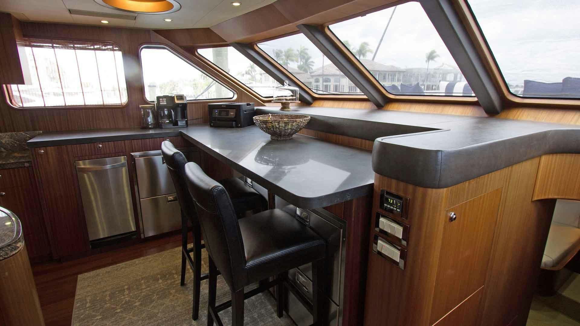 a kitchen with a table and chairs aboard JUS CHILL'N Yacht for Sale