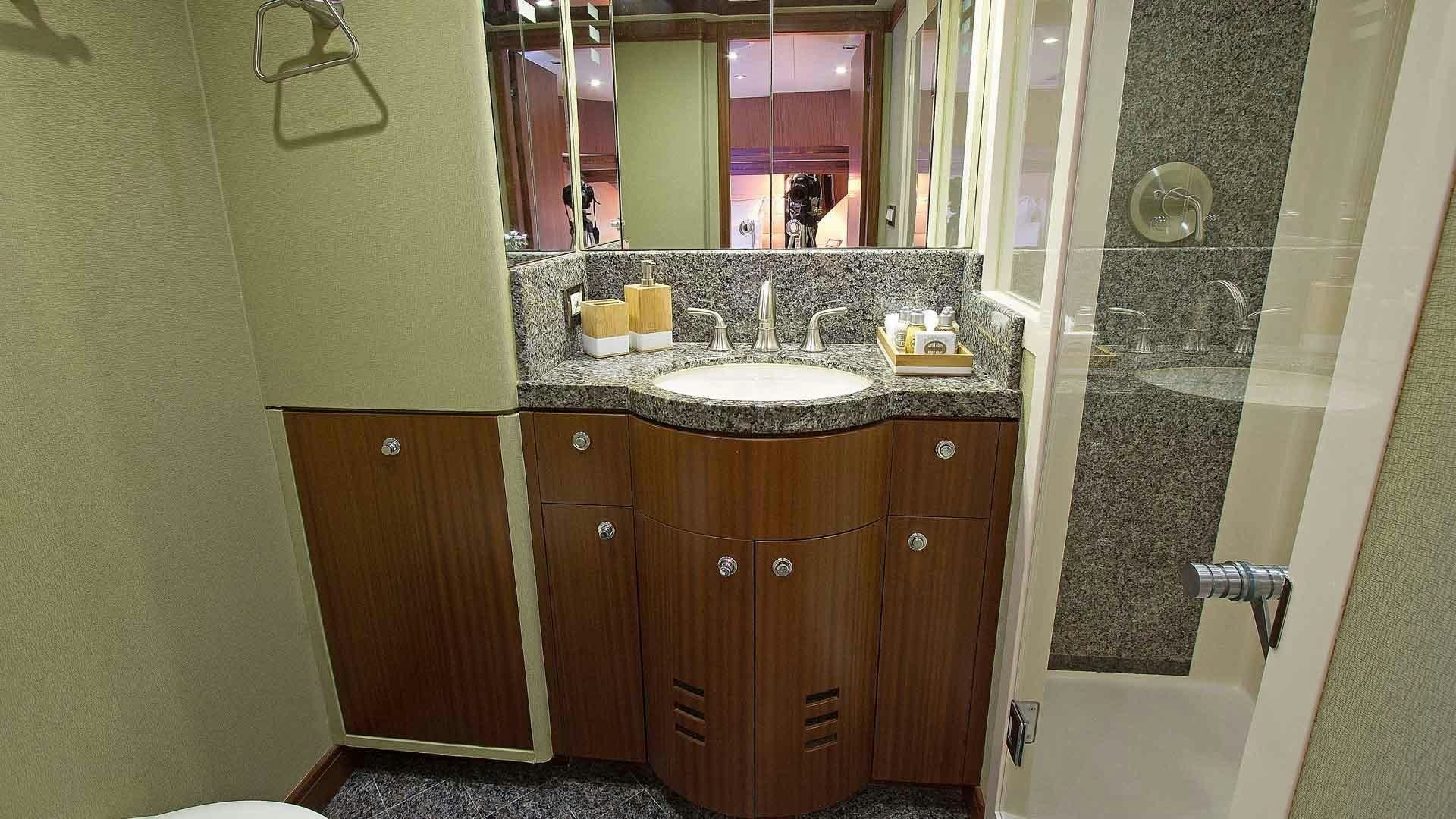 a bathroom with a large mirror aboard JUS CHILL'N Yacht for Sale