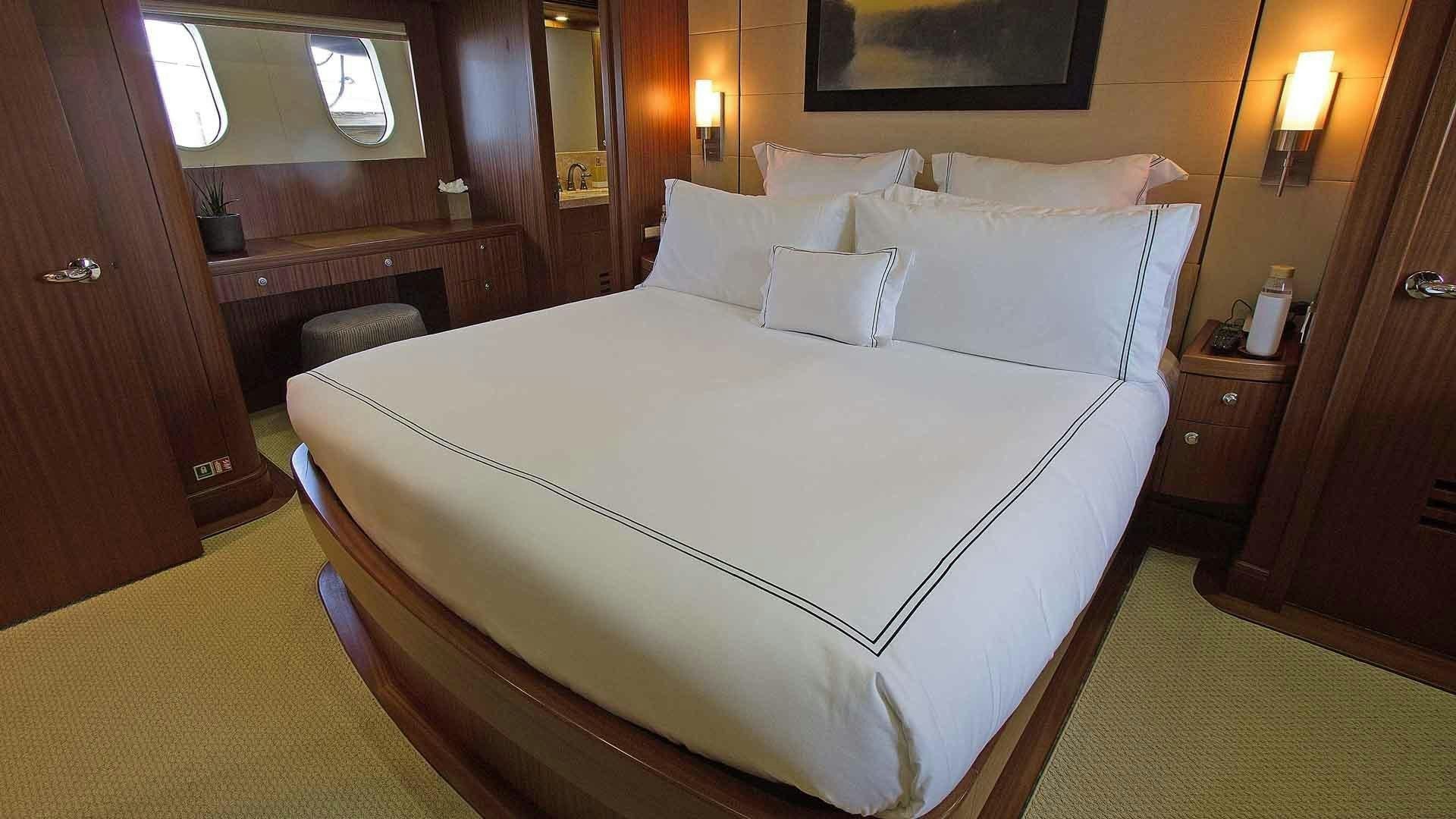 a bed with white sheets aboard JUS CHILL'N Yacht for Sale