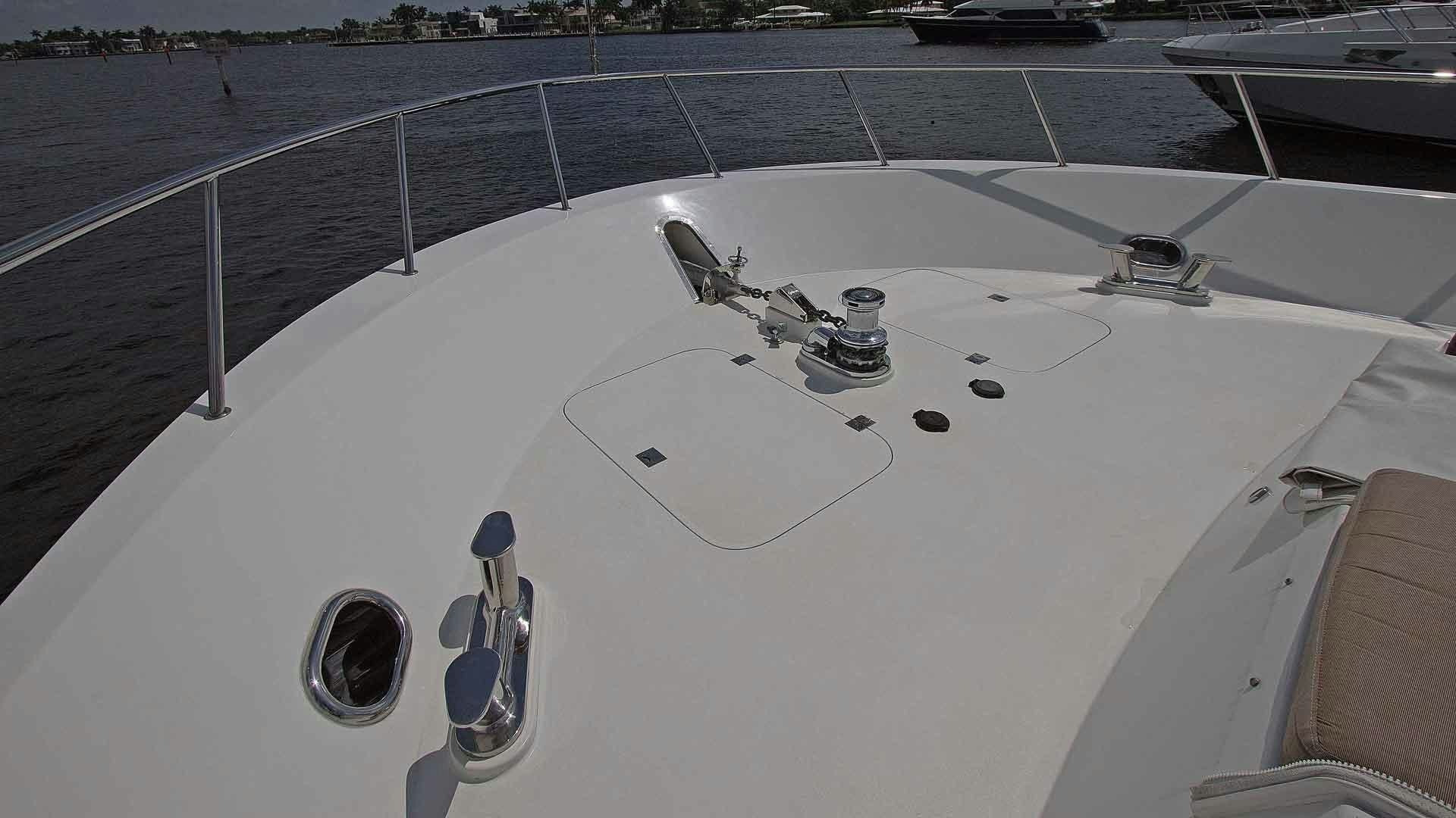a white boat with a metal bar on the front aboard JUS CHILL'N Yacht for Sale
