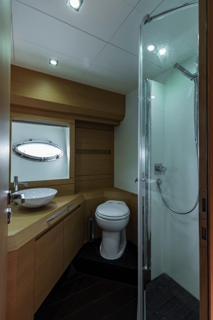 a bathroom with a glass shower aboard LOUNOR Yacht for Sale