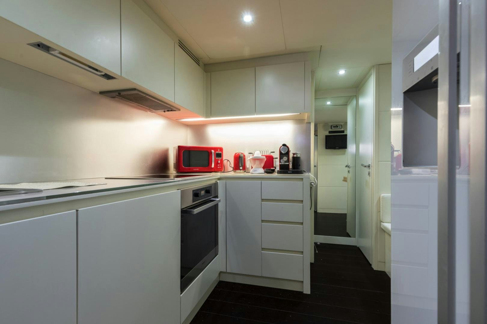 a kitchen with white cabinets aboard LOUNOR Yacht for Sale