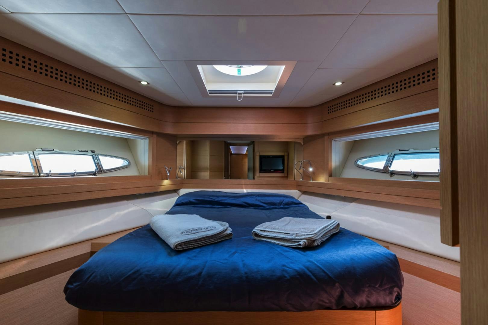 a room with a bed and a window aboard LOUNOR Yacht for Sale