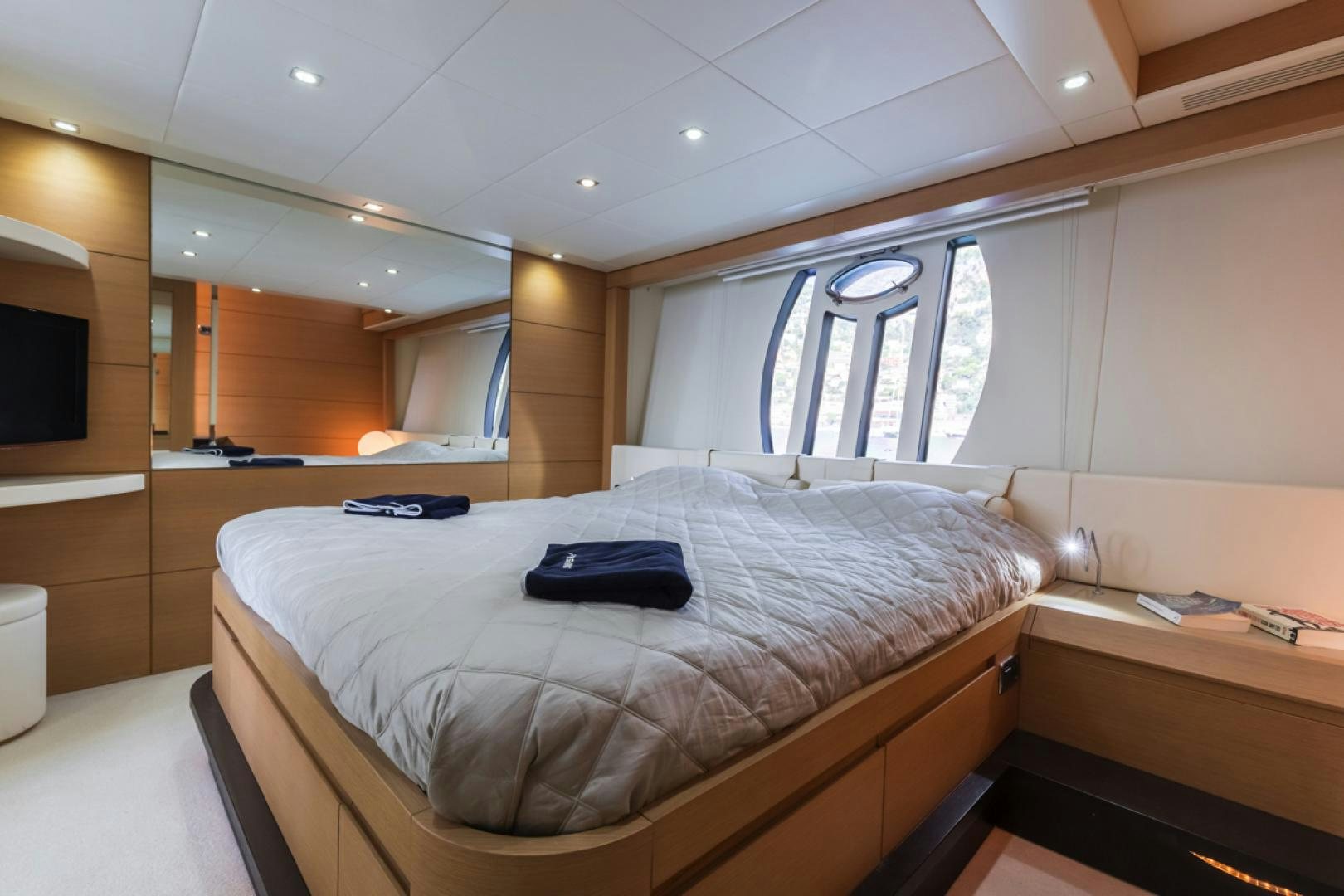 a room with a bed and desk aboard LOUNOR Yacht for Sale