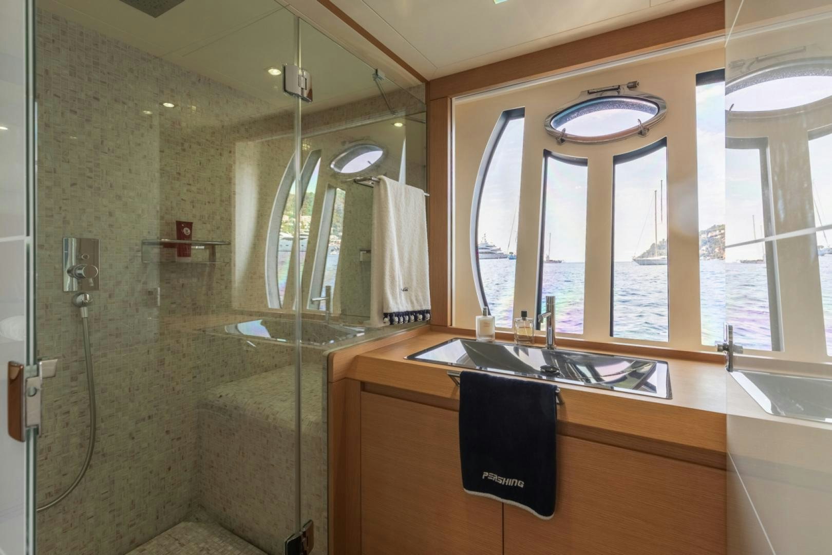 a bathroom with a glass shower aboard LOUNOR Yacht for Sale