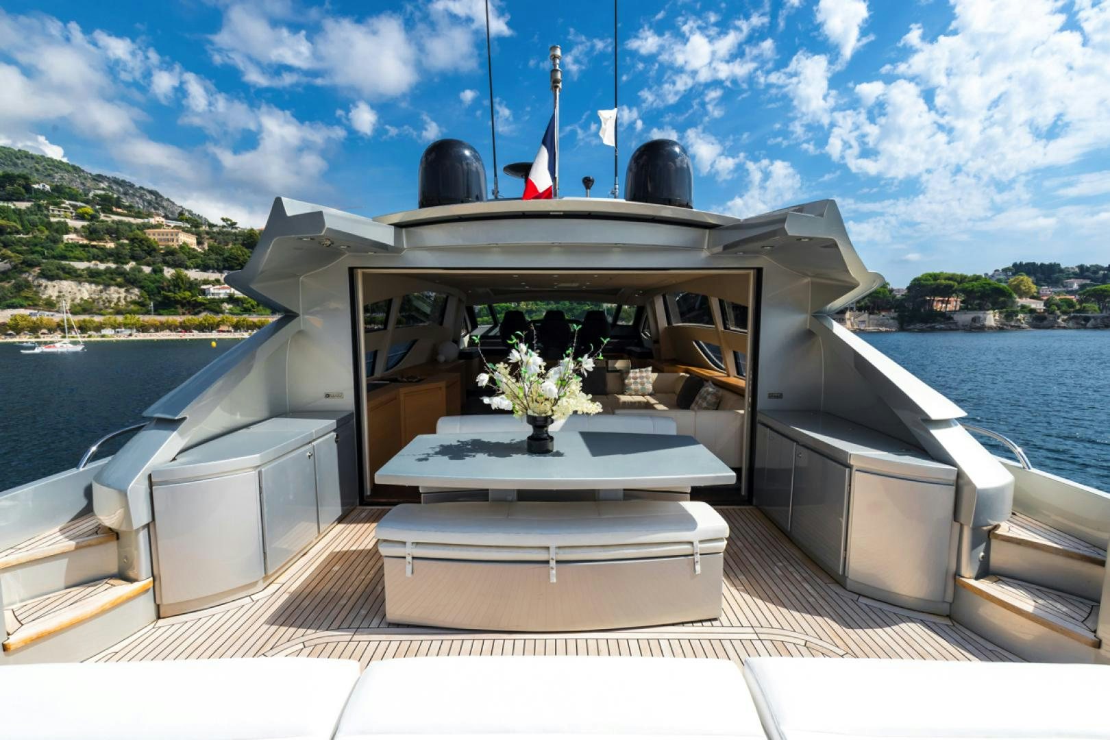 a fire pit with a body of water in the background aboard LOUNOR Yacht for Sale