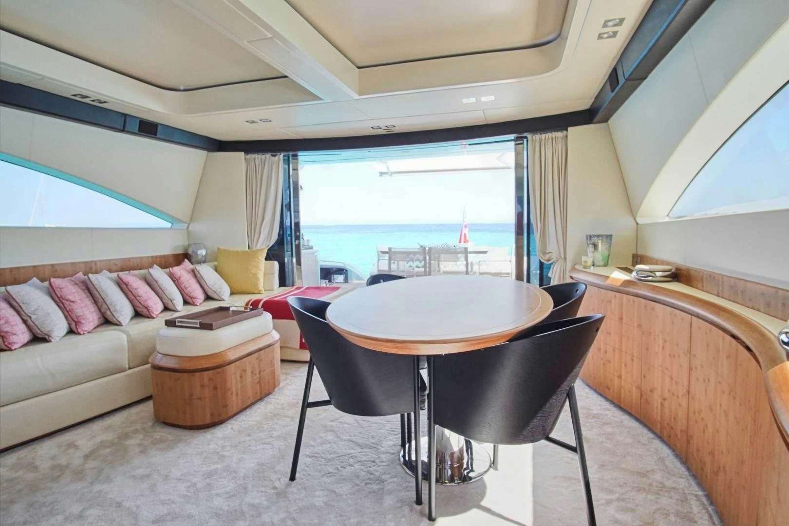 a living room with a table and couches aboard SYBER Yacht for Sale