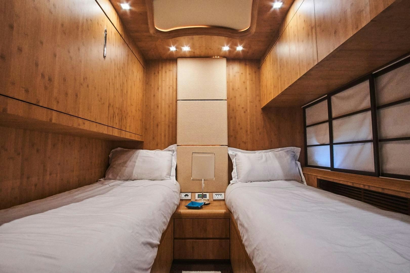 a room with two beds aboard SYBER Yacht for Sale