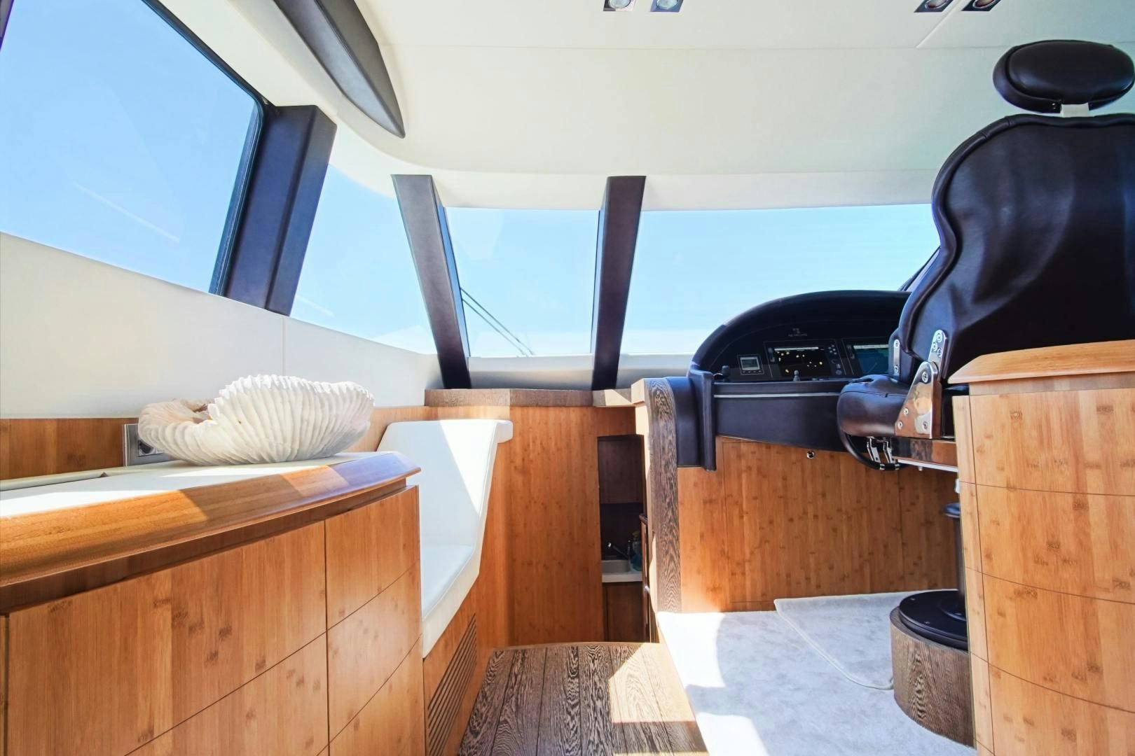 a boat with a chair and a table aboard SYBER Yacht for Sale