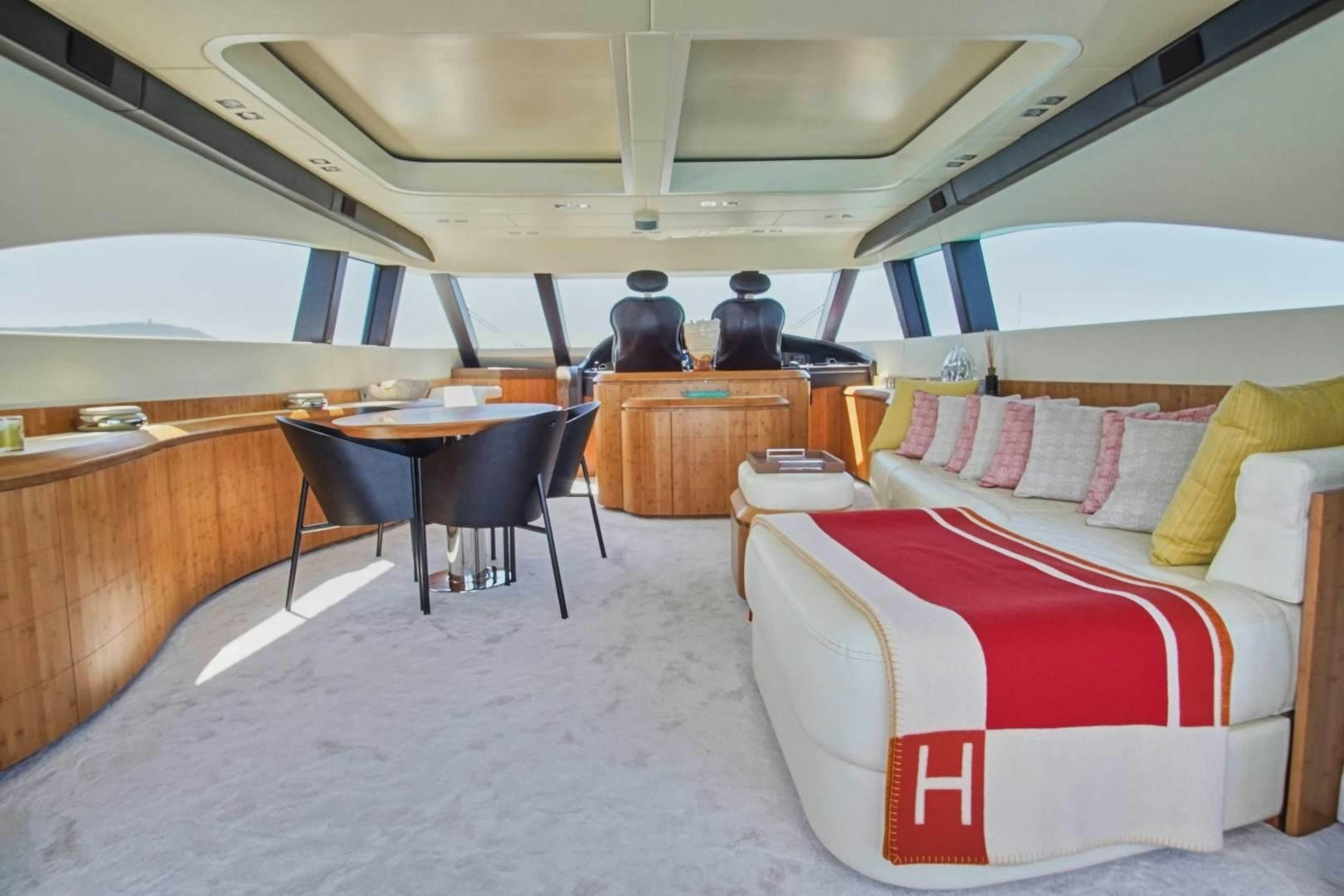 a room with a table and couch aboard SYBER Yacht for Sale