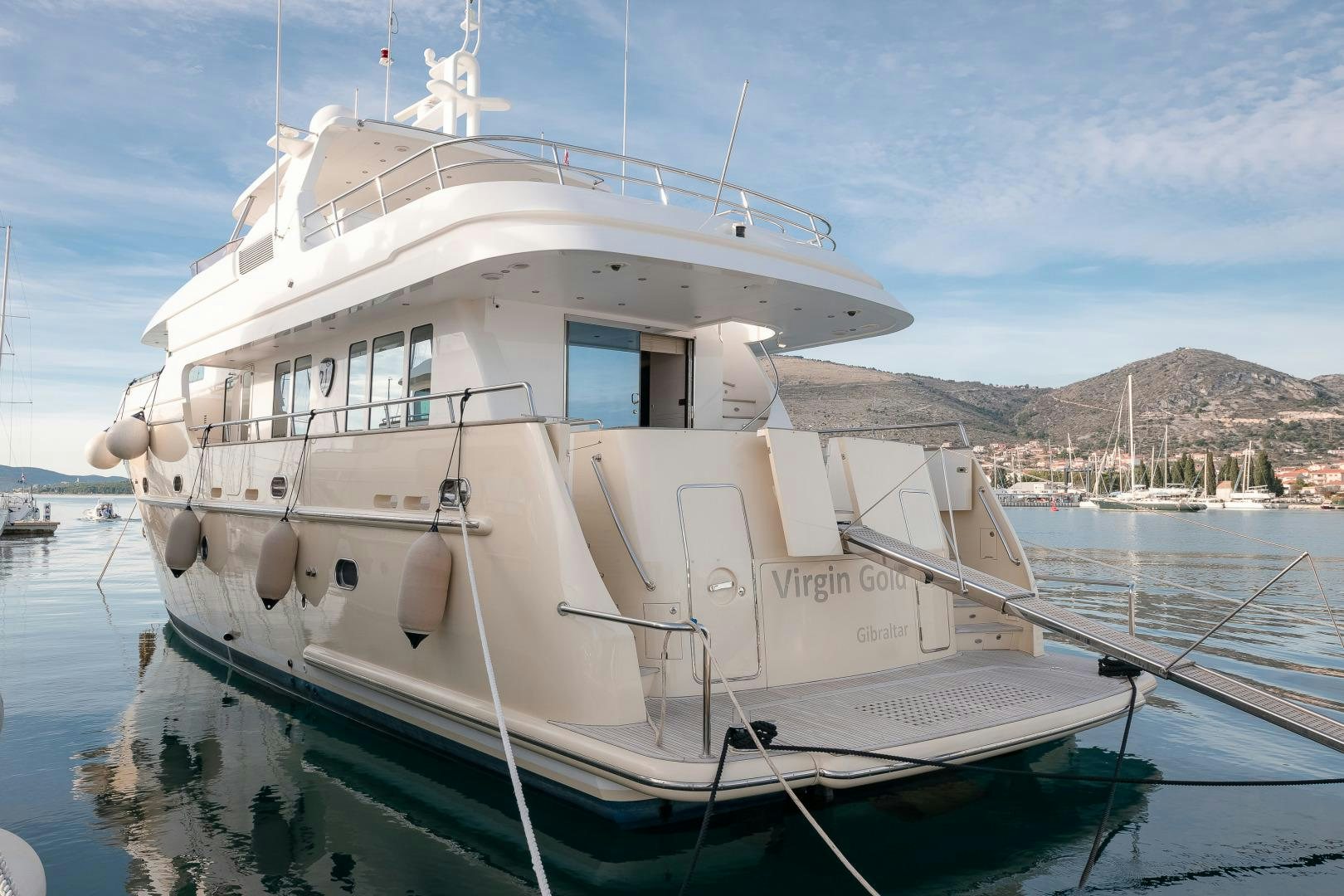 a white boat in the water aboard VIRGIN GOLD Yacht for Sale