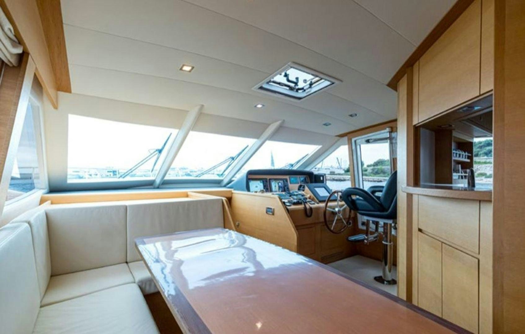 a room with a table and chairs aboard PASSION V Yacht for Sale