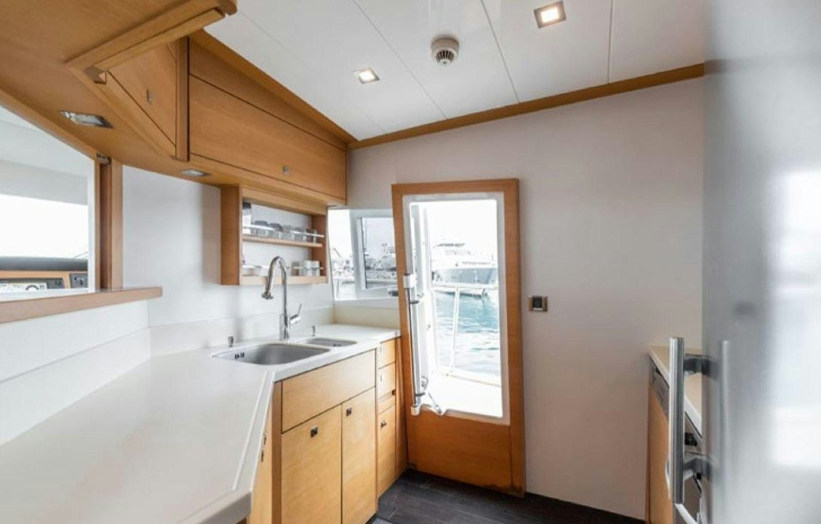 a kitchen with a sink and cabinets aboard PASSION V Yacht for Sale
