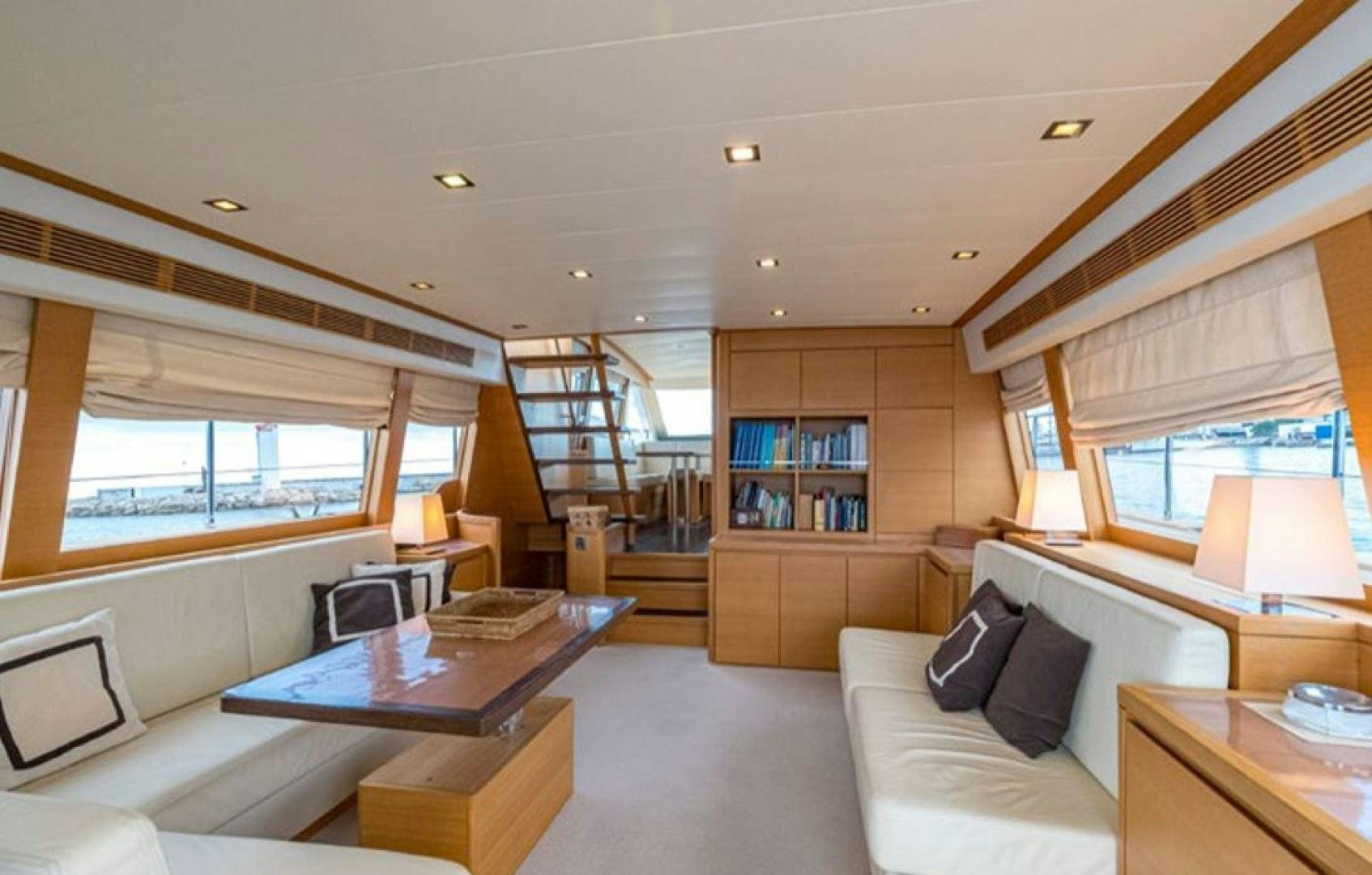 a living room with a large window aboard PASSION V Yacht for Sale
