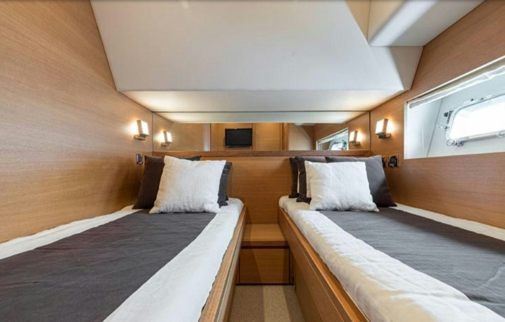 a room with two beds aboard PASSION V Yacht for Sale