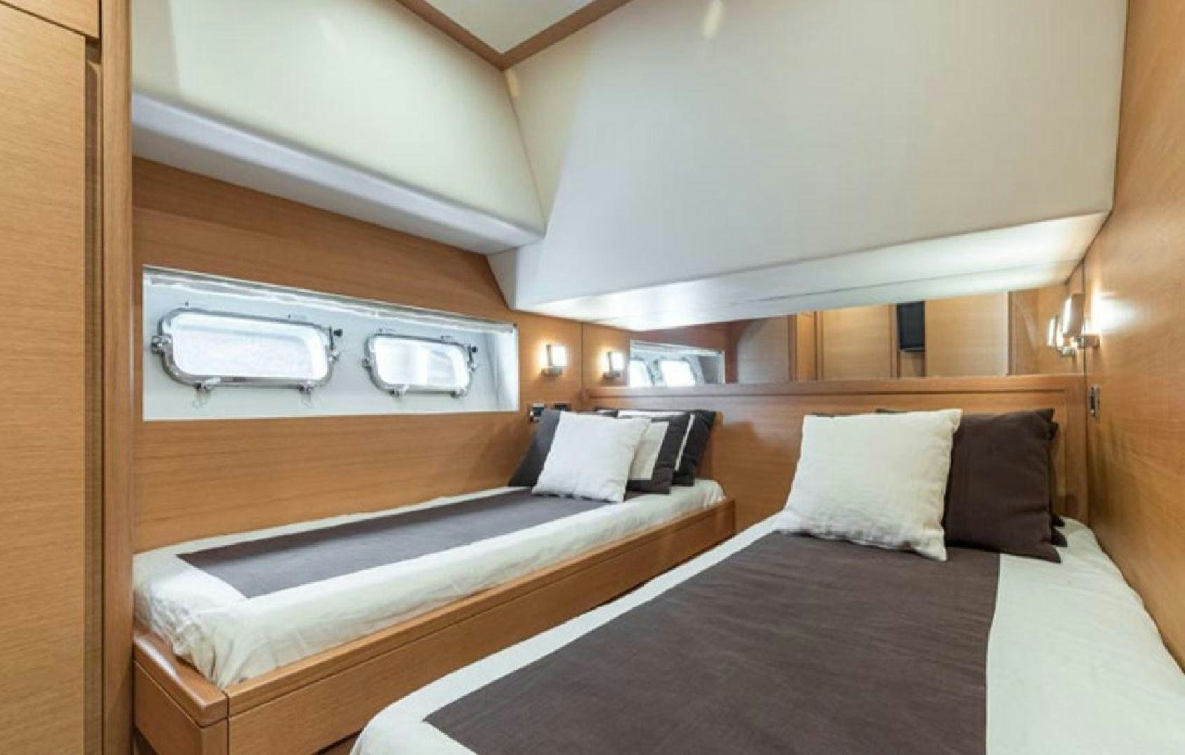 a room with two beds aboard PASSION V Yacht for Sale