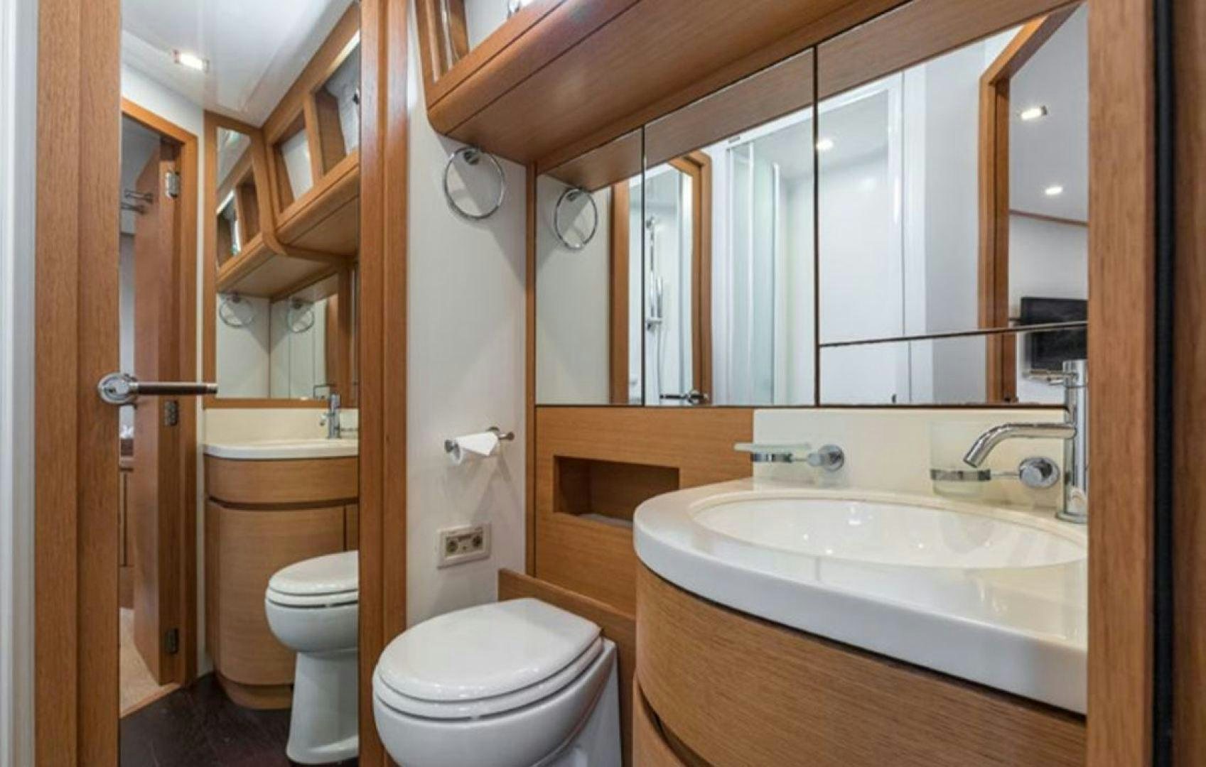 a bathroom with a sink toilet and bathtub aboard PASSION V Yacht for Sale