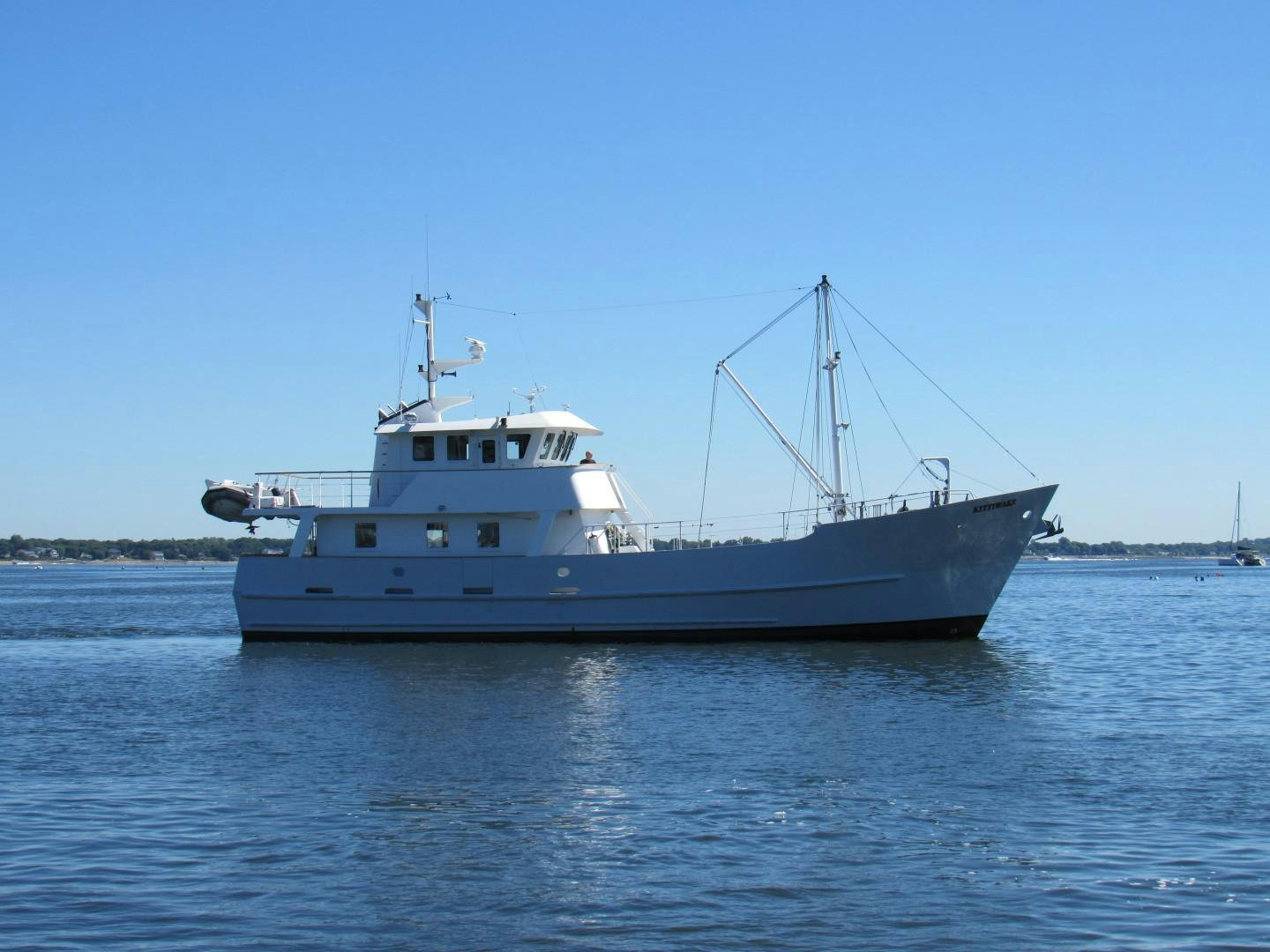 a large boat in the water aboard KITTIWAKE Yacht for Sale