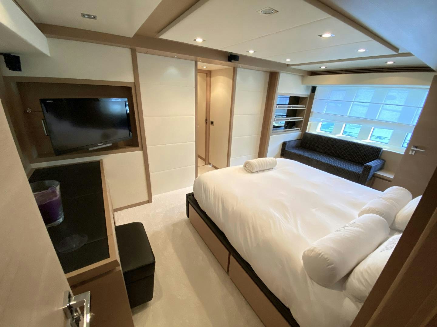 a room with a bed and a television aboard THOR Yacht for Sale