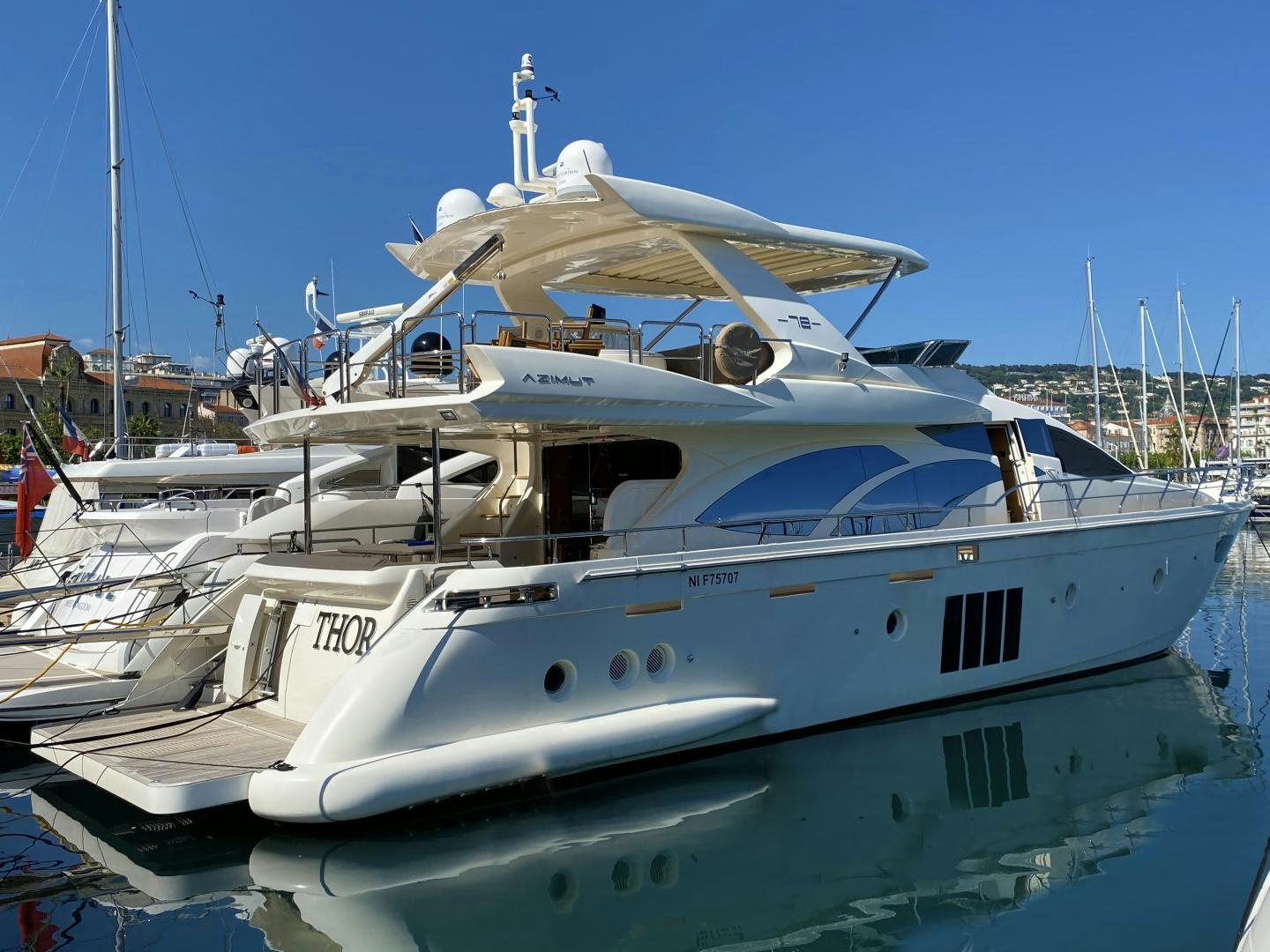 a white yacht in the water aboard THOR Yacht for Sale