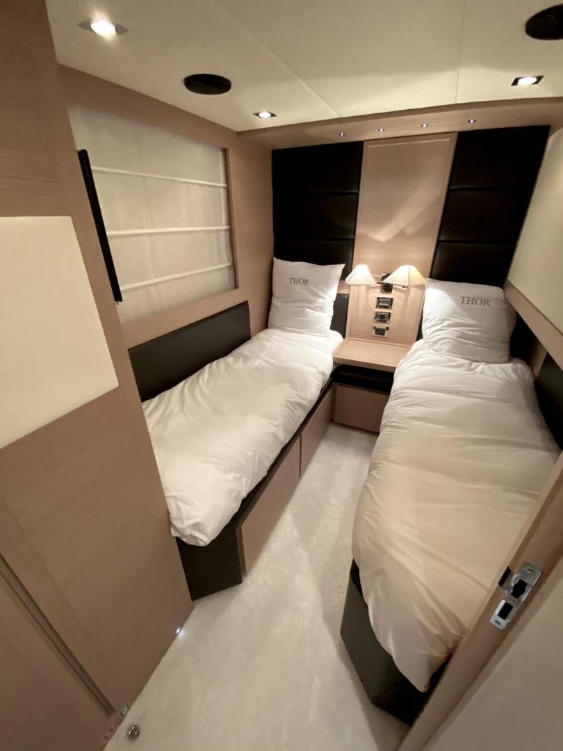 a couple of beds in a hotel room aboard THOR Yacht for Sale