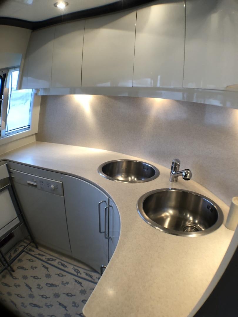 a kitchen with a sink and a rug aboard LADY J II Yacht for Sale