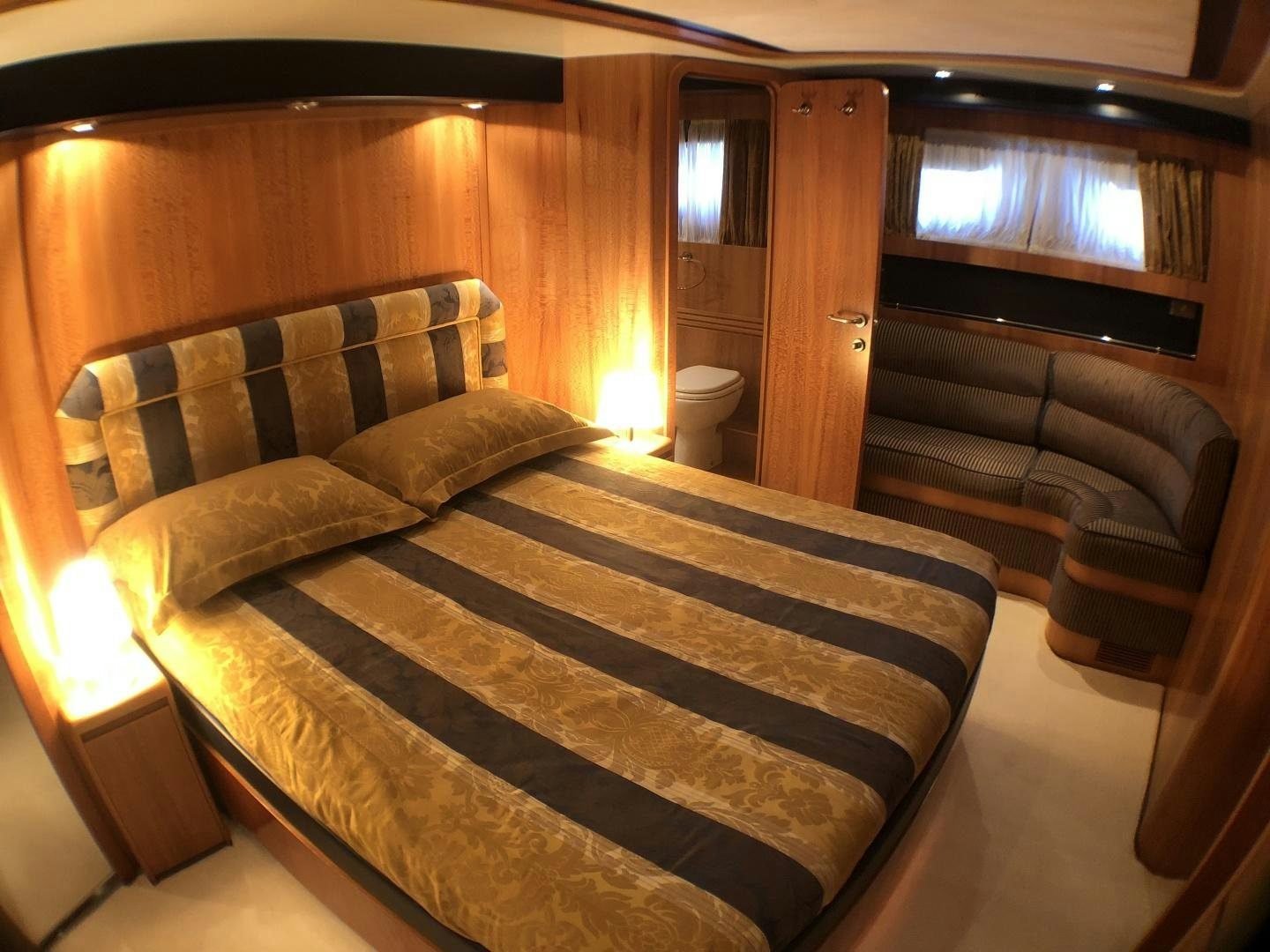 a bed with a white sheet aboard LADY J II Yacht for Sale