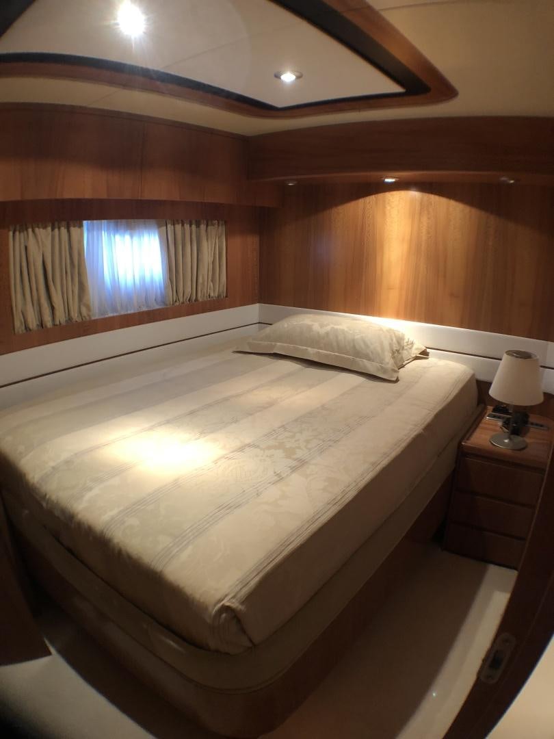 a bed with a white sheet aboard LADY J II Yacht for Sale