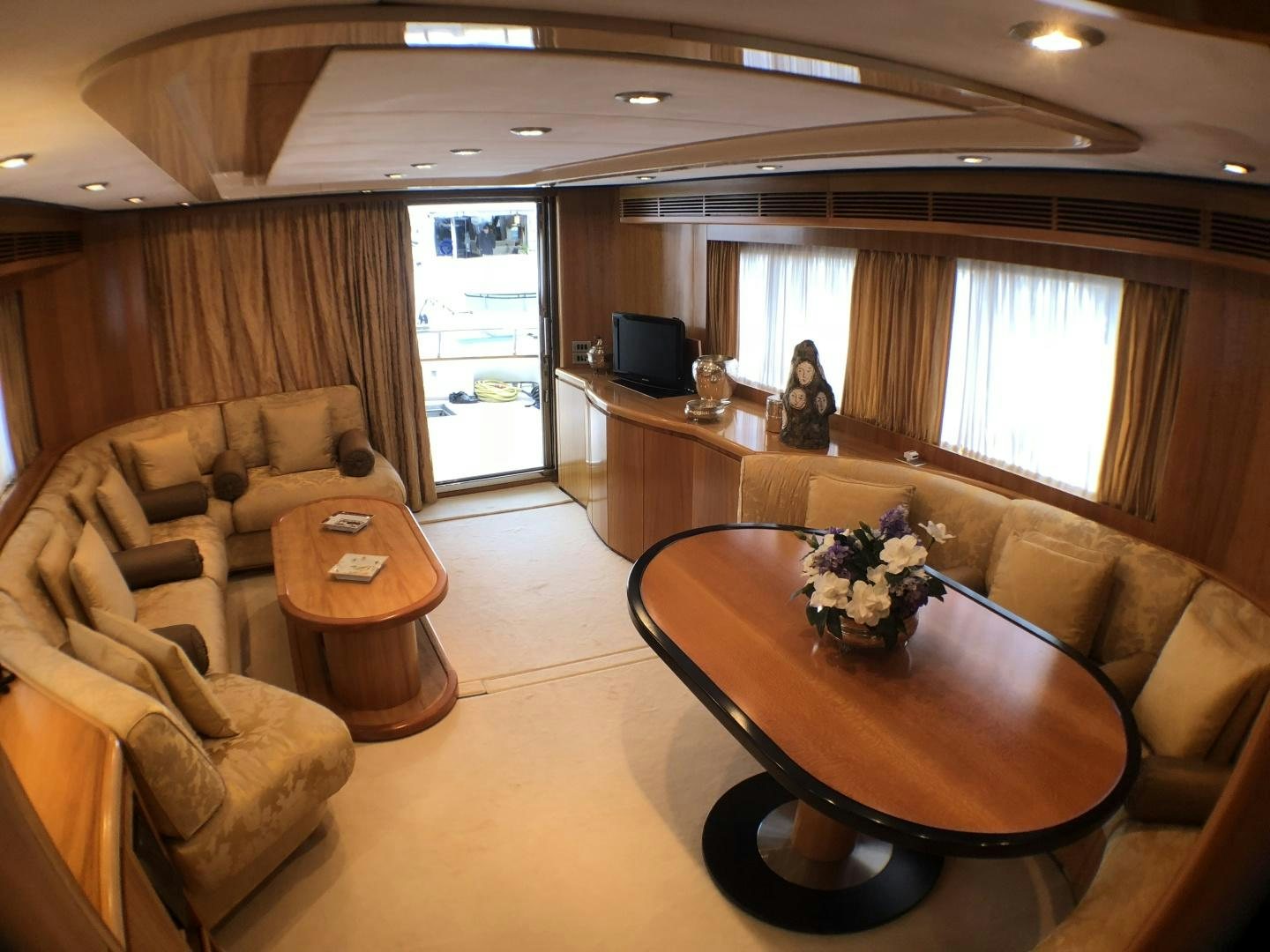 a living room with a couch and a coffee table aboard LADY J II Yacht for Sale