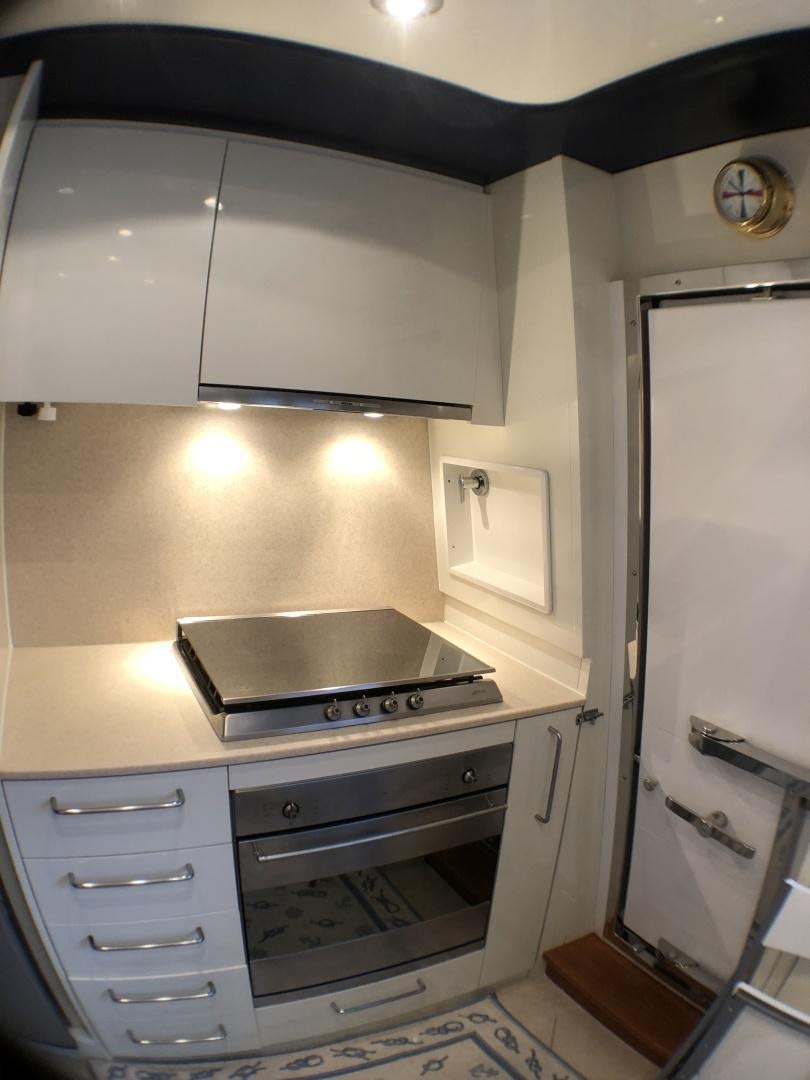 a kitchen with a stove and oven aboard LADY J II Yacht for Sale