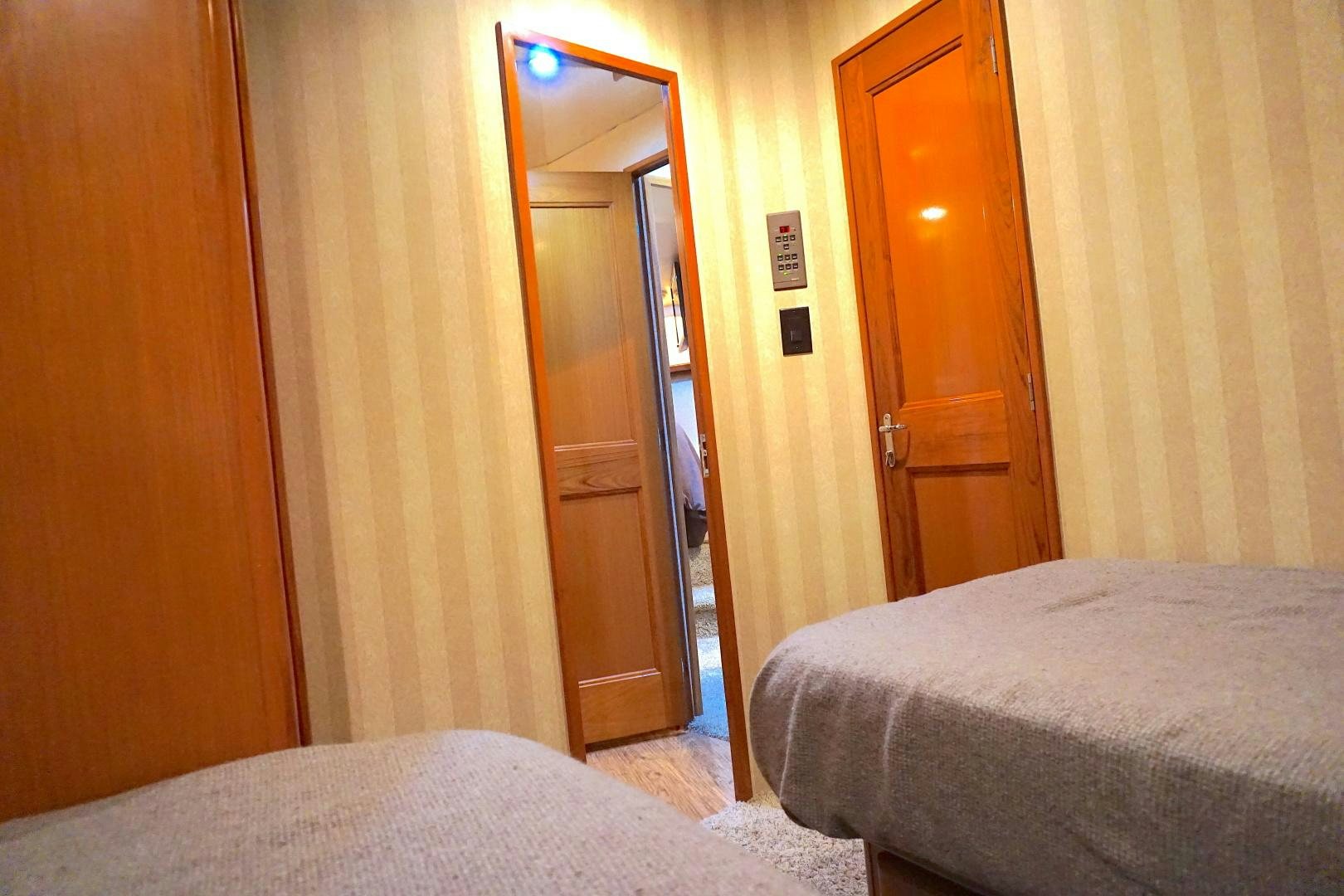 a hotel room with a bed and a mirror aboard CROWN ROYAL Yacht for Sale