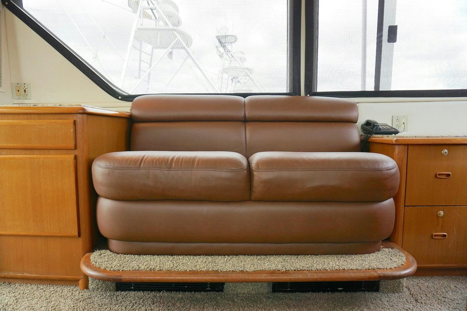 a brown leather couch aboard CROWN ROYAL Yacht for Sale