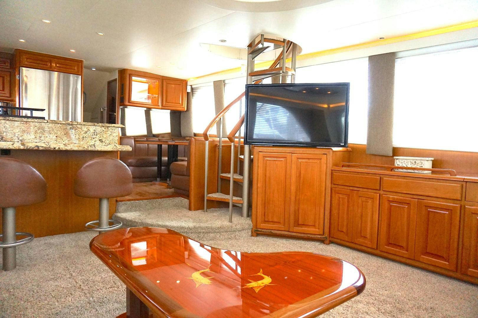 a living room with a tv and a fireplace aboard CROWN ROYAL Yacht for Sale