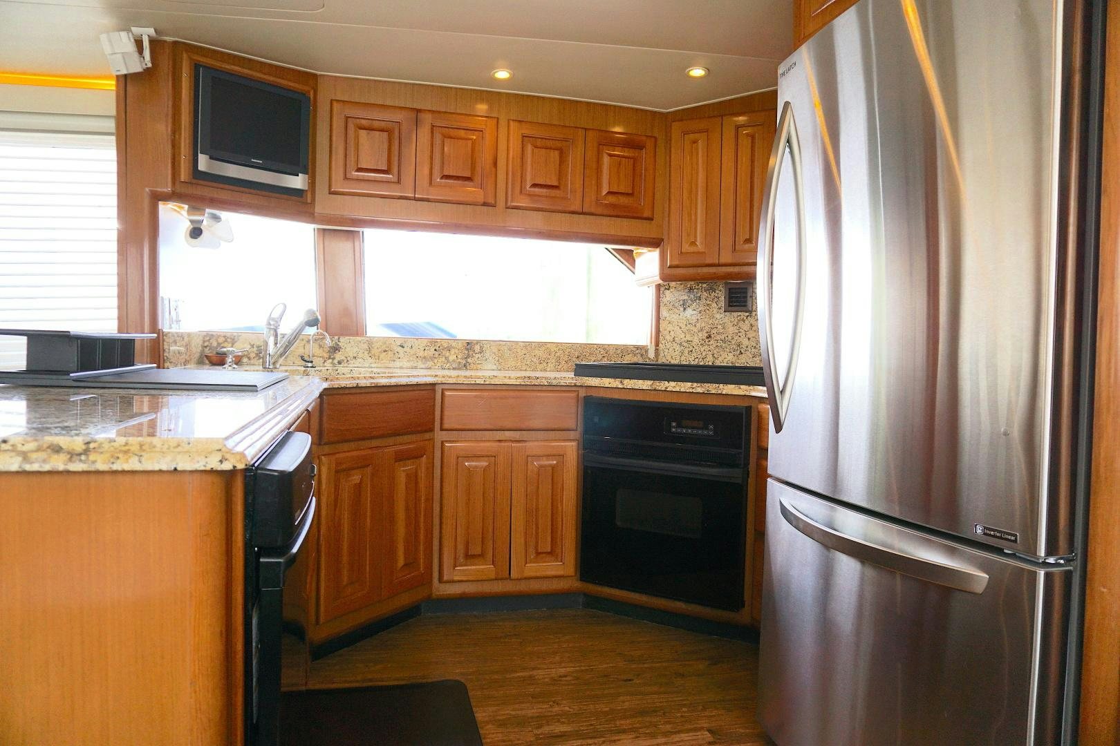 a kitchen with a stainless steel refrigerator aboard CROWN ROYAL Yacht for Sale