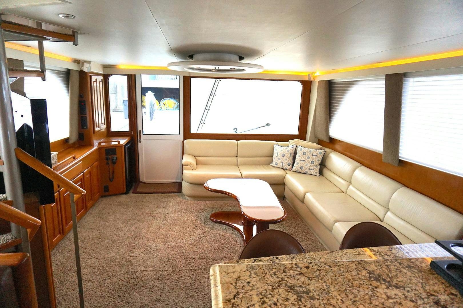 a living room with a couch and a table aboard CROWN ROYAL Yacht for Sale