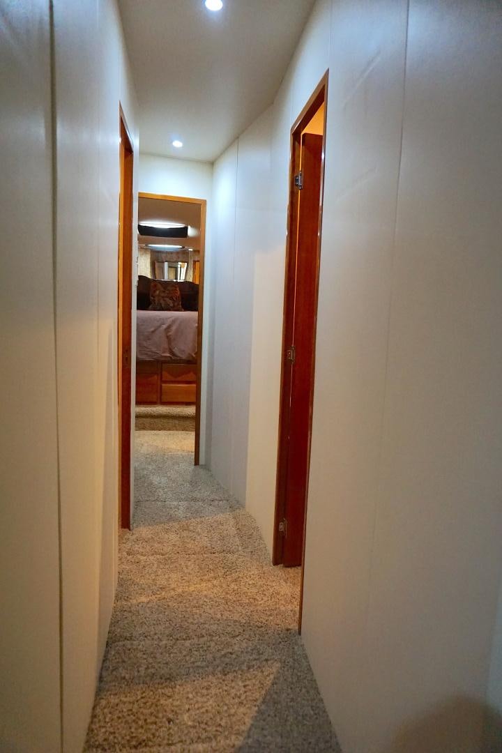 a hallway with a red door aboard CROWN ROYAL Yacht for Sale