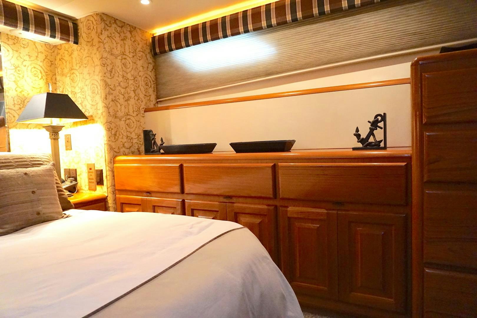 a bedroom with a bed and a desk aboard CROWN ROYAL Yacht for Sale