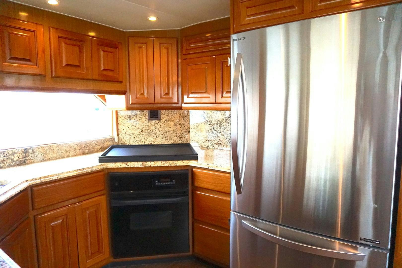 a kitchen with wooden cabinets aboard CROWN ROYAL Yacht for Sale