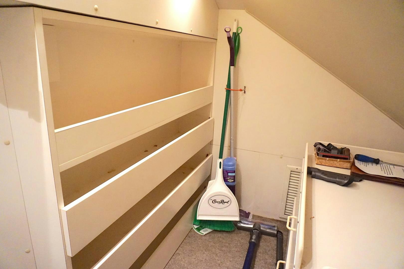 a white cabinet with a green handle aboard CROWN ROYAL Yacht for Sale