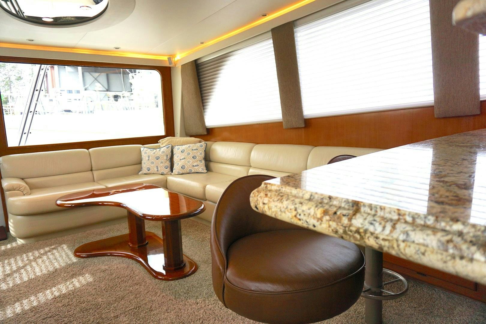 a living room with a couch and a table aboard CROWN ROYAL Yacht for Sale