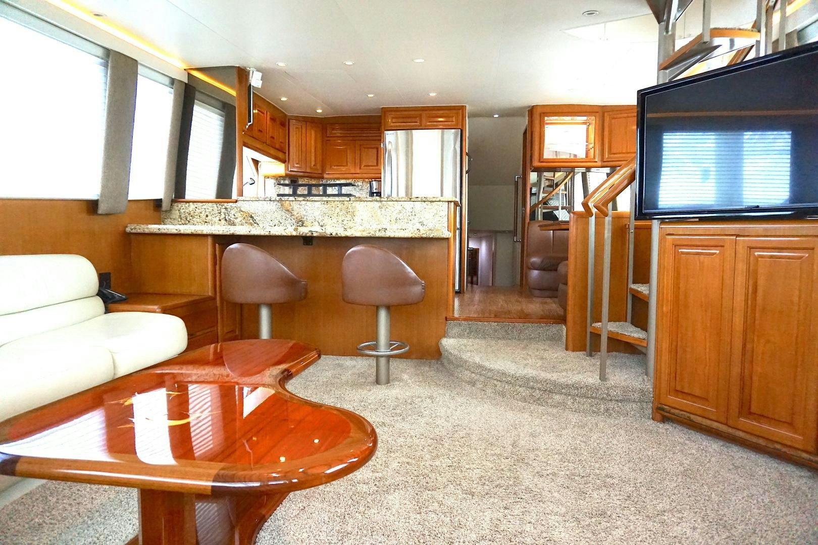 a living room with a table and chairs aboard CROWN ROYAL Yacht for Sale