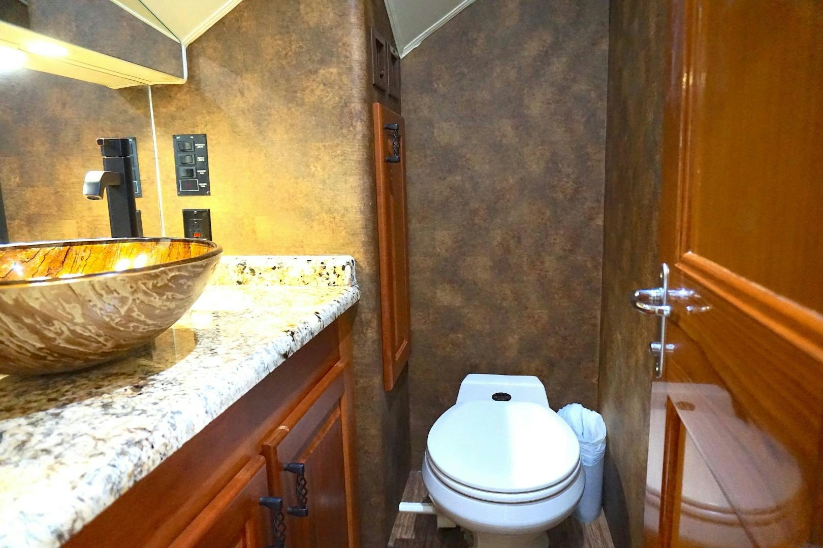 a bathroom with a sink toilet and a bathtub aboard CROWN ROYAL Yacht for Sale