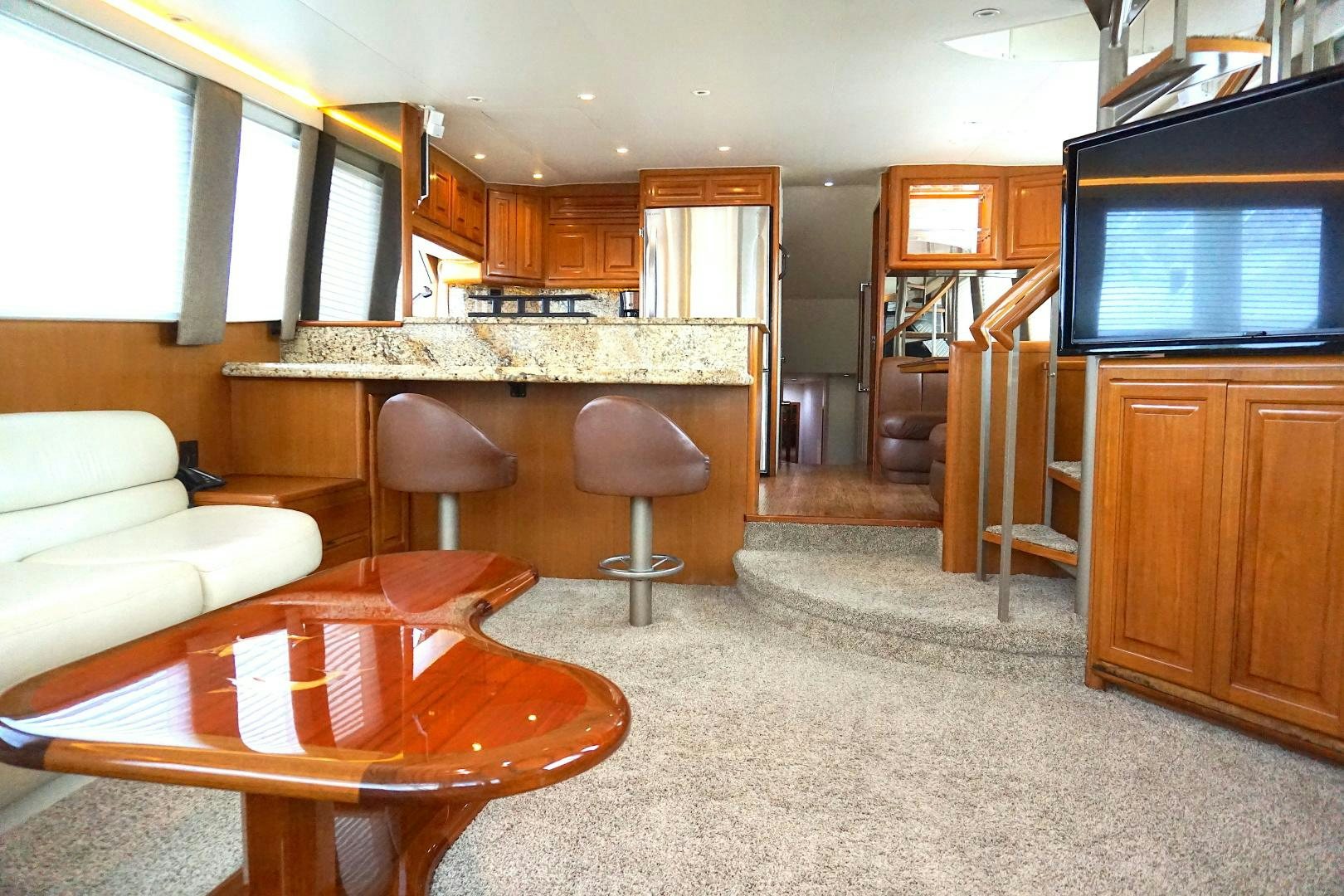 a living room with a table and chairs aboard CROWN ROYAL Yacht for Sale